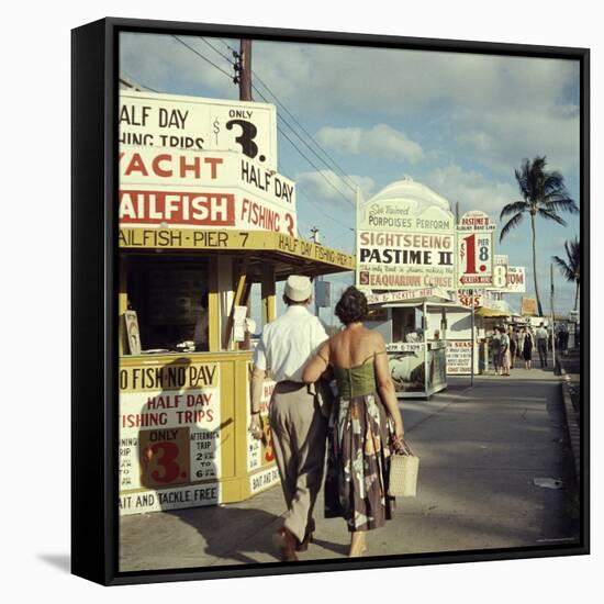 Vacationers Walking by Booths Advertising Boat Tours-Hank Walker-Framed Stretched Canvas