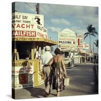 Vacationers Walking by Booths Advertising Boat Tours-Hank Walker-Stretched Canvas