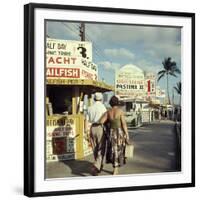 Vacationers Walking by Booths Advertising Boat Tours-Hank Walker-Framed Photographic Print