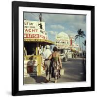 Vacationers Walking by Booths Advertising Boat Tours-Hank Walker-Framed Photographic Print
