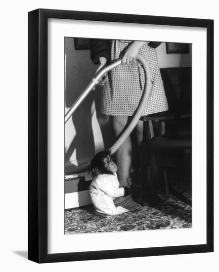Vacuuming with a Chimp-null-Framed Photographic Print