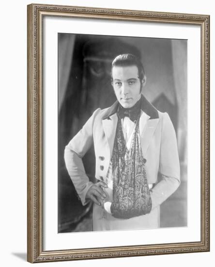 Valentino on the set of 'The Eagle' with his arm in a sling after a car accident, c.1925-null-Framed Photographic Print