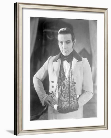 Valentino on the set of 'The Eagle' with his arm in a sling after a car accident, c.1925-null-Framed Photographic Print