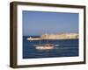 Valletta, A Fishing Boat Motors Out of the Entrance to the Grand Harbour Past Ricasoli Point, Malta-John Warburton-lee-Framed Photographic Print