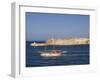 Valletta, A Fishing Boat Motors Out of the Entrance to the Grand Harbour Past Ricasoli Point, Malta-John Warburton-lee-Framed Photographic Print