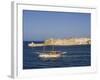 Valletta, A Fishing Boat Motors Out of the Entrance to the Grand Harbour Past Ricasoli Point, Malta-John Warburton-lee-Framed Photographic Print