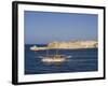 Valletta, A Fishing Boat Motors Out of the Entrance to the Grand Harbour Past Ricasoli Point, Malta-John Warburton-lee-Framed Photographic Print