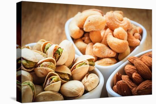 Varieties of Nuts: Cashew, Pistachio, Almond.-Voy-Stretched Canvas