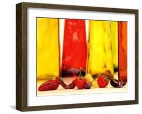 Various Types of Peppers in Front of Red & Yellow Bottles-Monica Varella-Framed Photographic Print