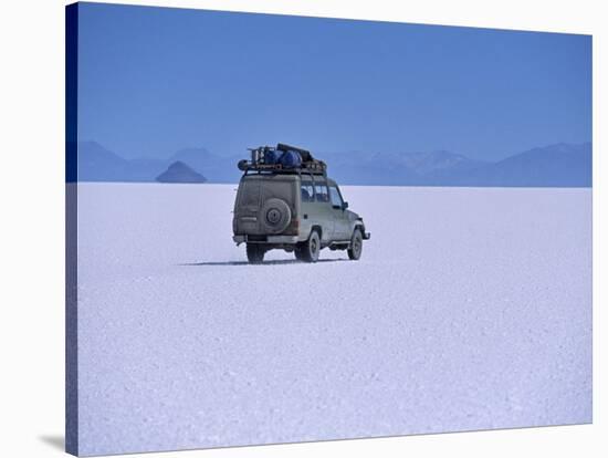 Vehicle Drives across the Crusted Salt of the Salar De Uyuni, the Largest Salt Flat in the World-John Warburton-lee-Stretched Canvas
