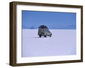 Vehicle Drives across the Crusted Salt of the Salar De Uyuni, the Largest Salt Flat in the World-John Warburton-lee-Framed Photographic Print