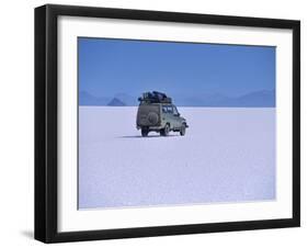 Vehicle Drives across the Crusted Salt of the Salar De Uyuni, the Largest Salt Flat in the World-John Warburton-lee-Framed Photographic Print