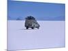 Vehicle Drives across the Crusted Salt of the Salar De Uyuni, the Largest Salt Flat in the World-John Warburton-lee-Mounted Photographic Print