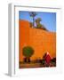 Veiled Woman Bicycling Below Red City Walls, Marrakech, Morocco-Merrill Images-Framed Photographic Print