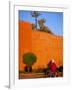 Veiled Woman Bicycling Below Red City Walls, Marrakech, Morocco-Merrill Images-Framed Photographic Print