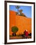 Veiled Woman Bicycling Below Red City Walls, Marrakech, Morocco-Merrill Images-Framed Photographic Print