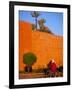 Veiled Woman Bicycling Below Red City Walls, Marrakech, Morocco-Merrill Images-Framed Photographic Print