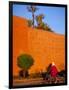 Veiled Woman Bicycling Below Red City Walls, Marrakech, Morocco-Merrill Images-Framed Photographic Print