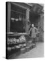 Vendor Standing Next to Vegetables, Eggs and Spices for Sale at Provision Market in Chinatown-null-Stretched Canvas