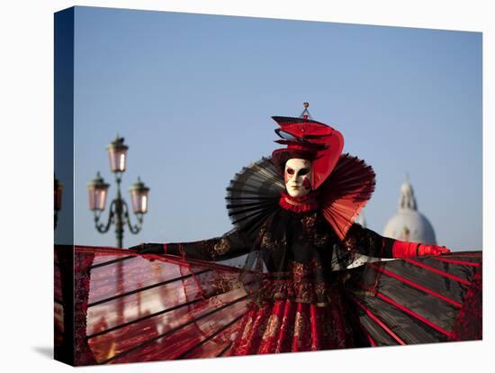 Venice, Veneto, Italy, a Mask in Costume on the Bacino Di San Marco with the Cupola of Santa Maria -Ken Scicluna-Stretched Canvas