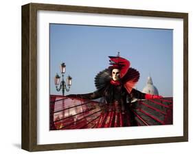 Venice, Veneto, Italy, a Mask in Costume on the Bacino Di San Marco with the Cupola of Santa Maria -Ken Scicluna-Framed Photographic Print