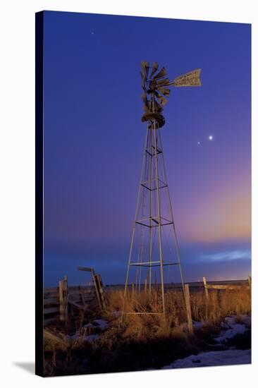 Venus and Jupiter are Visible Behind an Old Farm Water Pump Windmill, Alberta, Canada-null-Stretched Canvas