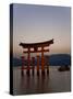 Vermillion Coloured 'Floating' Torii Gate Illuminated at Dusk, a Shinto Shrine Gate, Miyajima-Gavin Hellier-Stretched Canvas