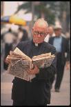 Episcopalian Priest Reading a Newspaper While Walking in Street, New York City-Vernon Merritt III-Photographic Print