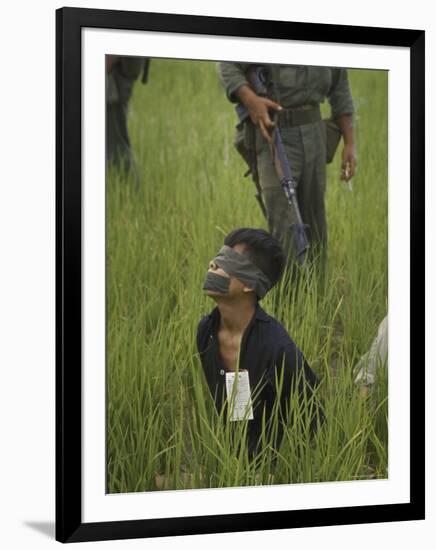 Viet Cong Prisoner Being Guarded by Marines, Mouth and Eyes Taped to Prevent From Calling for Help-Paul Schutzer-Framed Photographic Print