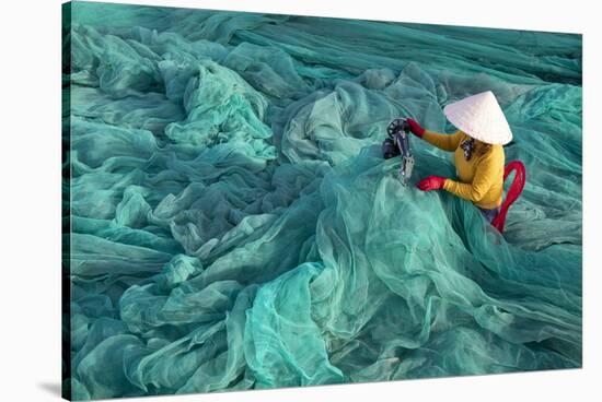 Vietnam. Fishing net analysis and repair with old fashioned manual sowing machine.-Tom Norring-Stretched Canvas