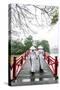 Vietnam, Hanoi, Hoan Kiem Lake. Walking on Huc Bridge in Traditional Ao Dai Dress-Matteo Colombo-Stretched Canvas