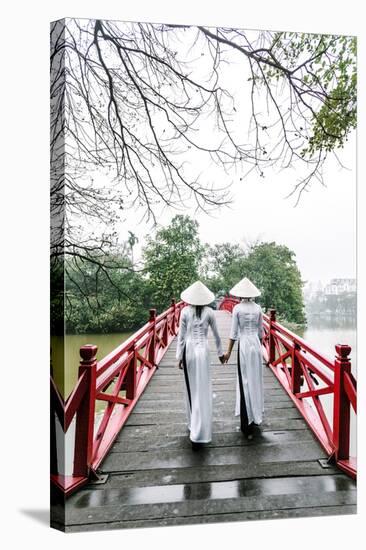Vietnam, Hanoi, Hoan Kiem Lake. Walking on Huc Bridge in Traditional Ao Dai Dress-Matteo Colombo-Stretched Canvas