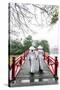 Vietnam, Hanoi, Hoan Kiem Lake. Walking on Huc Bridge in Traditional Ao Dai Dress-Matteo Colombo-Stretched Canvas