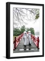 Vietnam, Hanoi, Hoan Kiem Lake. Walking on Huc Bridge in Traditional Ao Dai Dress-Matteo Colombo-Framed Premium Photographic Print