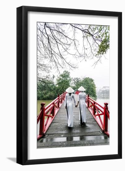 Vietnam, Hanoi, Hoan Kiem Lake. Walking on Huc Bridge in Traditional Ao Dai Dress-Matteo Colombo-Framed Premium Photographic Print