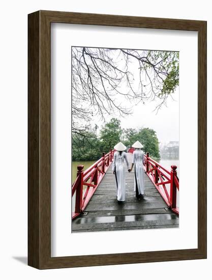 Vietnam, Hanoi, Hoan Kiem Lake. Walking on Huc Bridge in Traditional Ao Dai Dress-Matteo Colombo-Framed Photographic Print