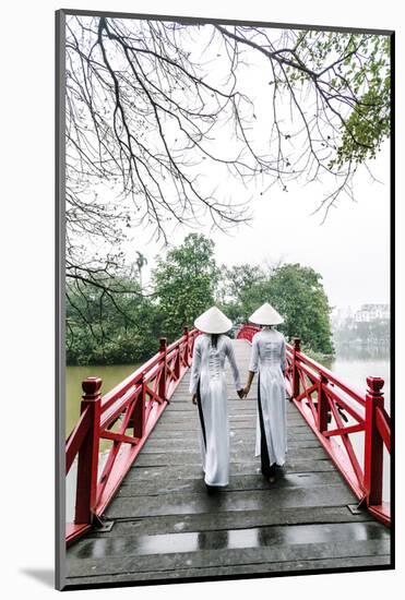 Vietnam, Hanoi, Hoan Kiem Lake. Walking on Huc Bridge in Traditional Ao Dai Dress-Matteo Colombo-Mounted Photographic Print