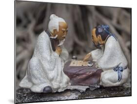 Vietnam, Hanoi. Temple of Literature, painted ceramics of 2 men playing traditional game.-Merrill Images-Mounted Photographic Print