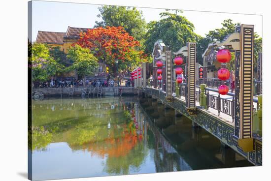 Vietnam. Hoi An bridge over the river with reflections and silk lamps.-Tom Norring-Stretched Canvas