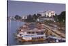 Vietnam, Hue. Cityscape with the Perfume River and Dragon Boats at Dusk-Walter Bibikow-Stretched Canvas