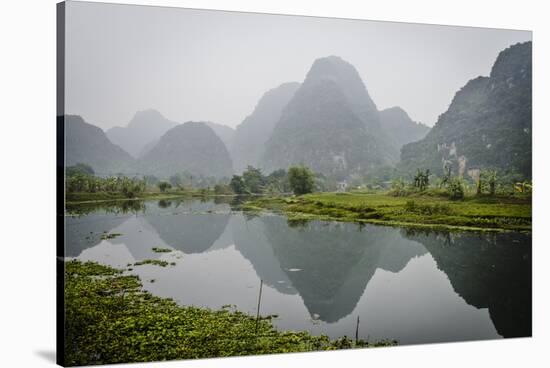 Vietnam, Ninh Binh. Limestone Karsts, with Reflection, in Fog-Matt Freedman-Stretched Canvas