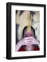 Vietnamese woman in red traditional long dress Ao Dai praying with incense sticks-Godong-Framed Photographic Print