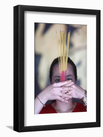 Vietnamese woman in red traditional long dress Ao Dai praying with incense sticks-Godong-Framed Photographic Print