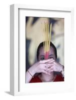Vietnamese woman in red traditional long dress Ao Dai praying with incense sticks-Godong-Framed Photographic Print
