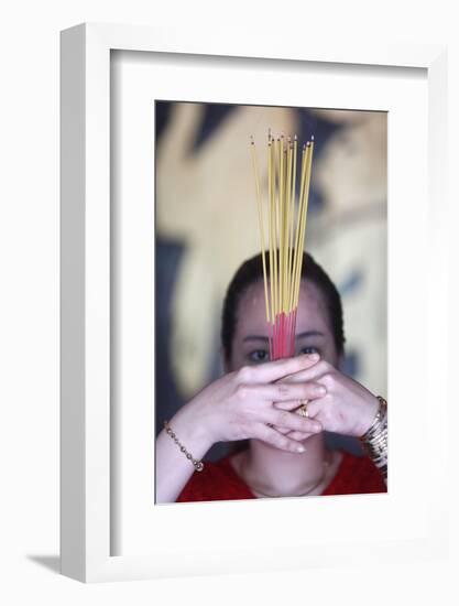 Vietnamese woman in red traditional long dress Ao Dai praying with incense sticks-Godong-Framed Photographic Print