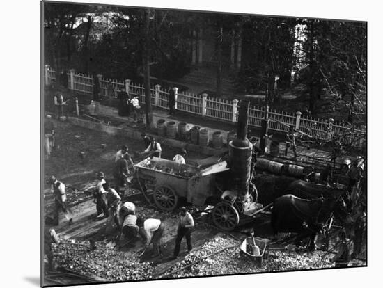 View from Above of Many Men Hard at Work Paving a Street-George B^ Brainerd-Mounted Photographic Print