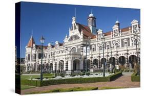 View from gardens to the imposing facade of Dunedin Railway Station, Anzac Square, Dunedin, Otago, -Ruth Tomlinson-Stretched Canvas