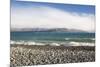 View from rocky shoreline across the stormy waters of Lake Pukaki, near Twizel, Mackenzie district,-Ruth Tomlinson-Mounted Photographic Print