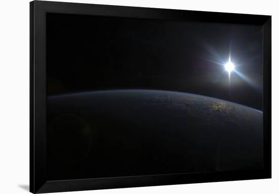 View from Space of the Sun Setting over Earth's Horizon-null-Framed Photographic Print