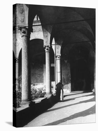 View of a Monk Walking the Grounds of a Church in Milan-Carl Mydans-Stretched Canvas